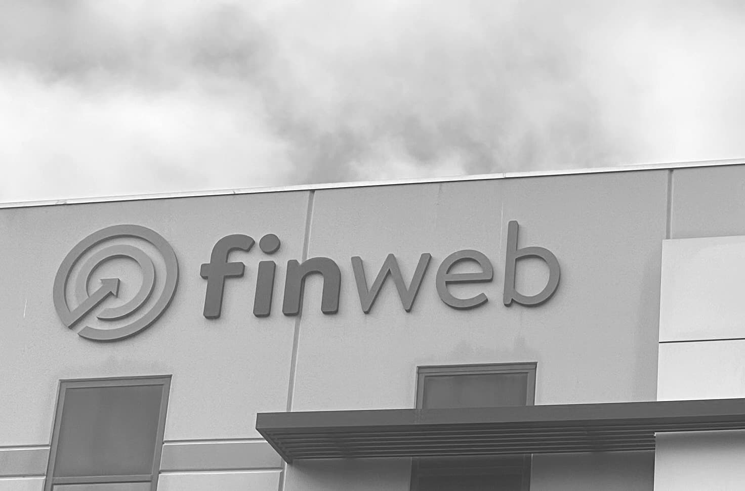 Finweb branding displayed on the wall of a Finweb workplace.